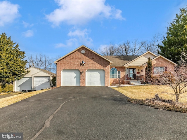 single story home with a garage, a porch, aphalt driveway, and brick siding