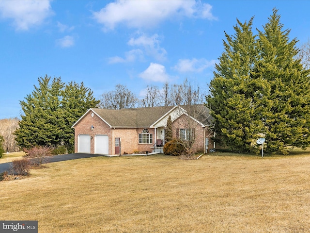 ranch-style house with a front lawn, an attached garage, brick siding, and aphalt driveway