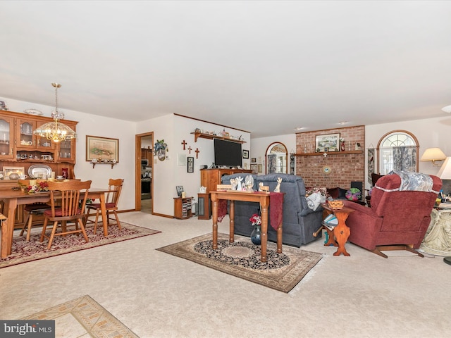 living room with light carpet, a notable chandelier, and baseboards