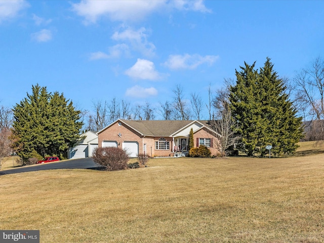 single story home featuring an attached garage, a front lawn, and brick siding