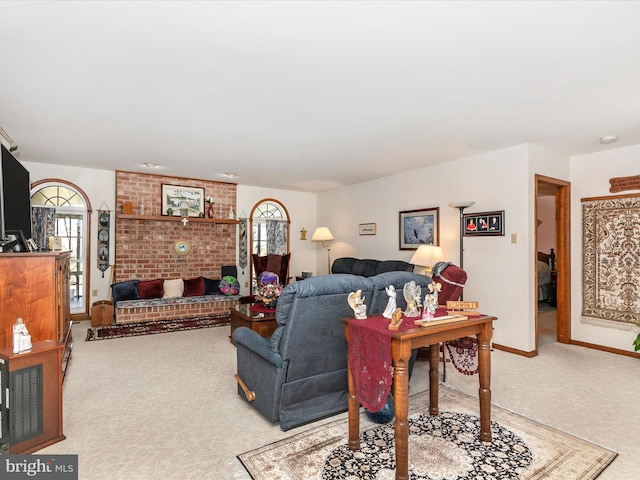 living room featuring a healthy amount of sunlight, carpet, and baseboards