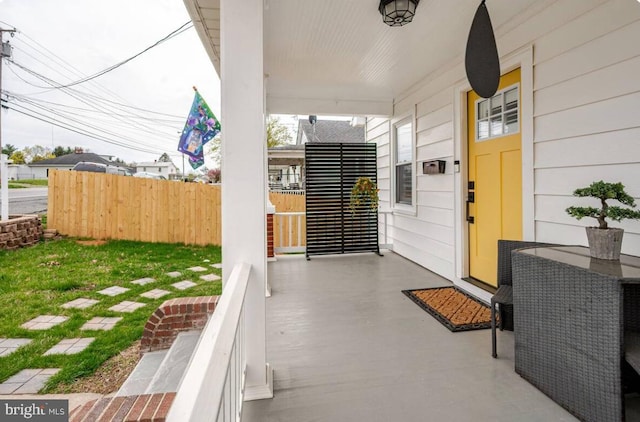 view of patio with fence and covered porch