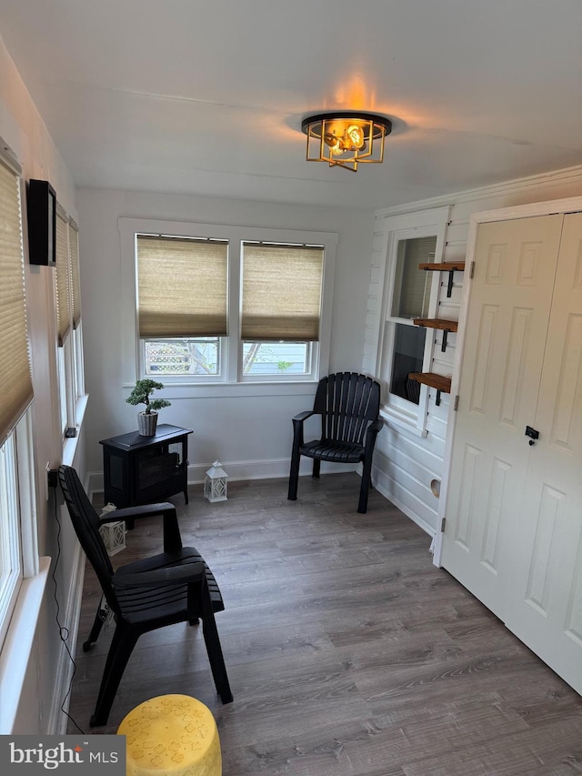 sitting room with baseboards and wood finished floors