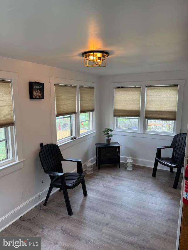 sitting room featuring baseboards and wood finished floors