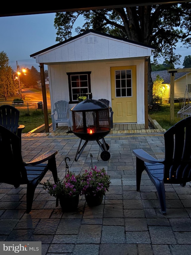 821 Jefferson Ave, Charles Town, WV 25414 - view of patio featuring fence, an outdoor structure, and a fire pit