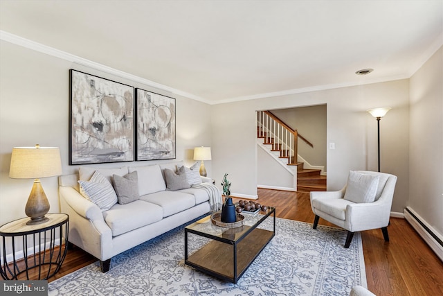 living room with stairway, wood finished floors, baseboards, and baseboard heating