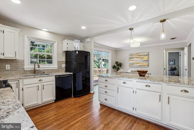 kitchen featuring white cabinets, black appliances, light wood-style flooring, and a sink