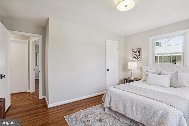 bedroom with wood finished floors and baseboards