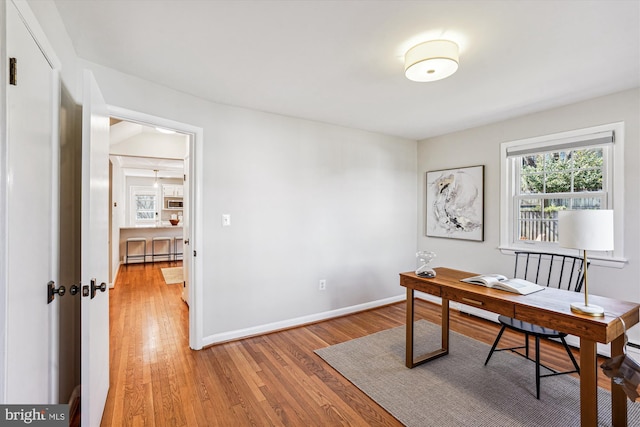 office with light wood-style flooring and baseboards