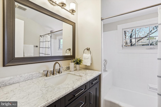 full bathroom featuring visible vents, plenty of natural light, shower / tub combo, and vanity