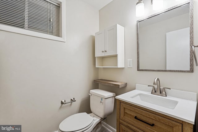 half bath featuring toilet and vanity