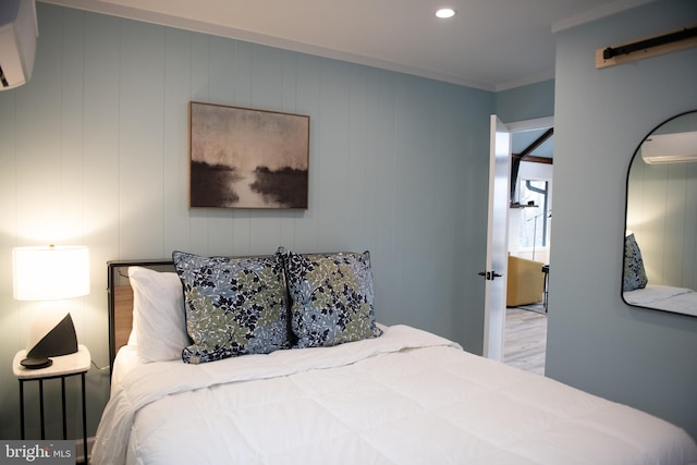 bedroom featuring ornamental molding, recessed lighting, a wall mounted AC, and wood finished floors