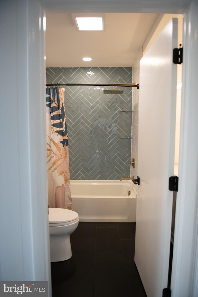 bathroom with tile patterned flooring, shower / tub combo, and toilet