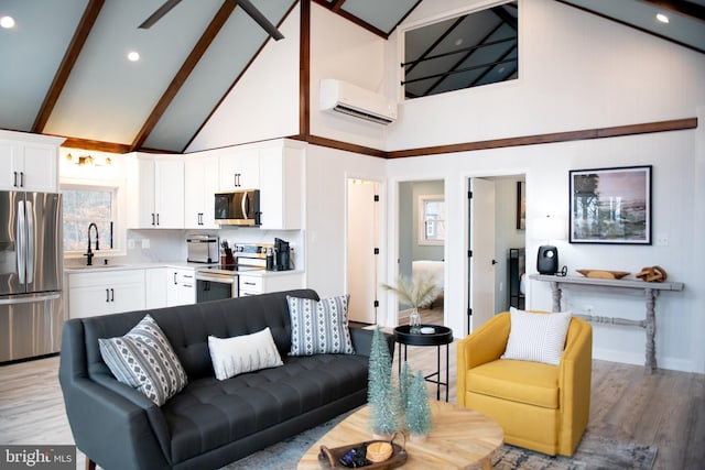 living room with high vaulted ceiling, baseboards, light wood-style floors, a wall mounted AC, and beamed ceiling