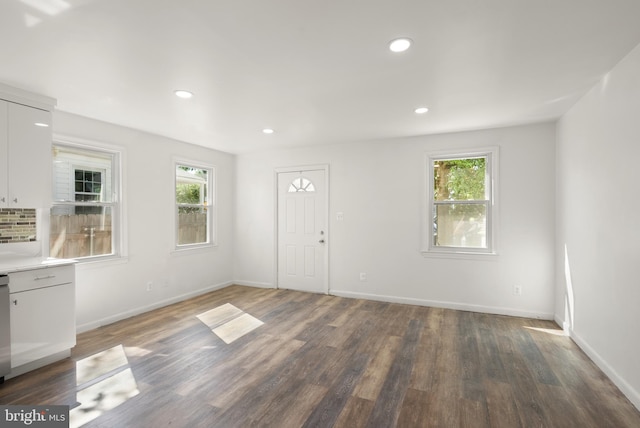 foyer entrance with recessed lighting, baseboards, wood finished floors, and a healthy amount of sunlight