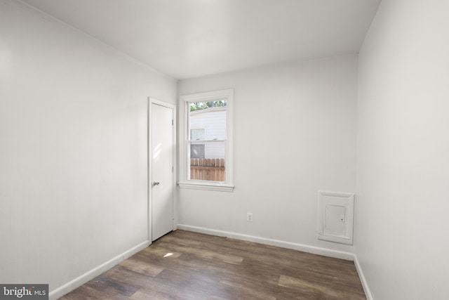 empty room with baseboards and wood finished floors