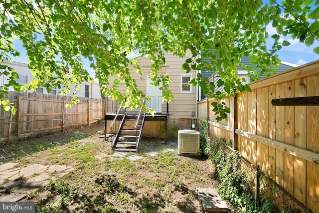view of yard featuring a fenced backyard and central air condition unit