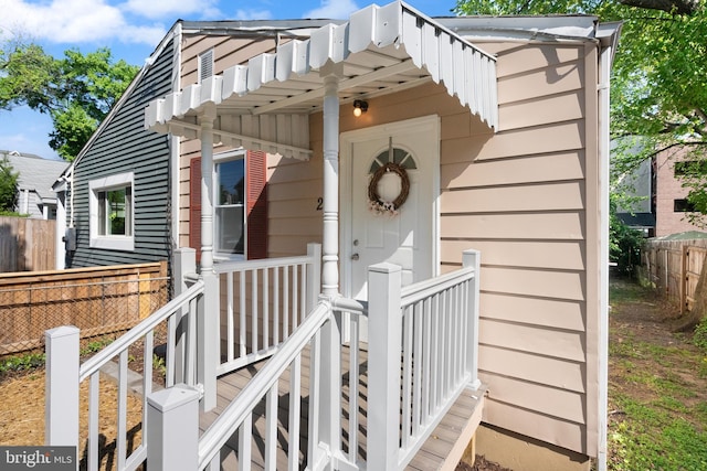 doorway to property with fence