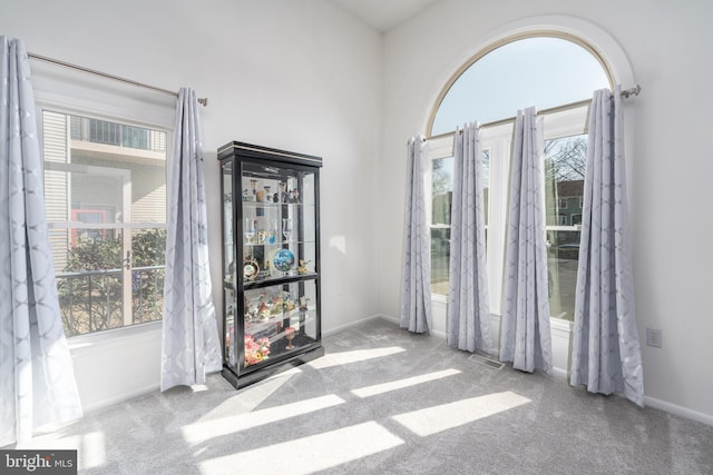 interior space with a healthy amount of sunlight, visible vents, and baseboards