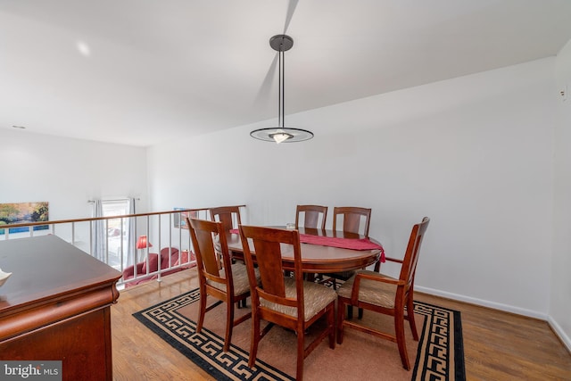 dining room featuring wood finished floors and baseboards