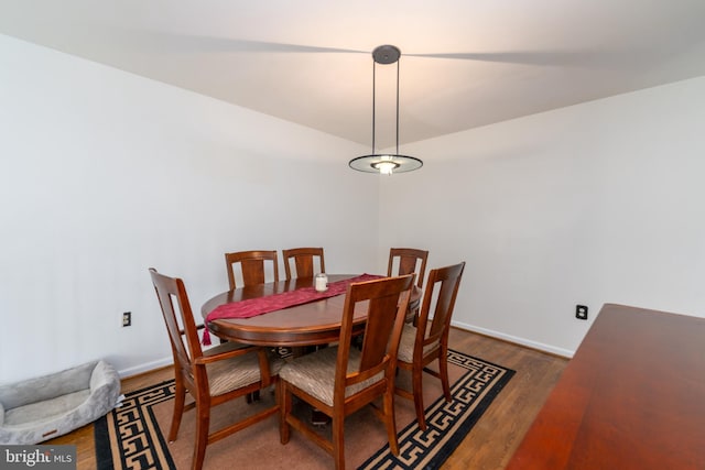 dining space featuring baseboards and wood finished floors