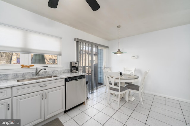 kitchen featuring light tile patterned floors, ceiling fan, a sink, light stone countertops, and dishwasher