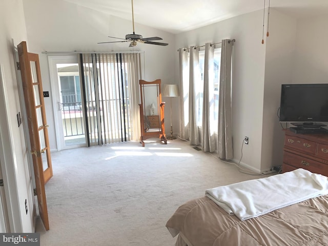 carpeted bedroom featuring lofted ceiling and access to exterior