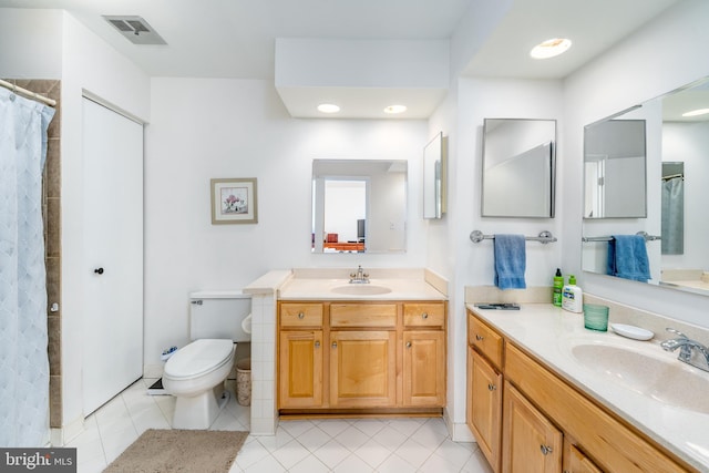 full bathroom featuring tile patterned flooring, two vanities, a sink, and visible vents