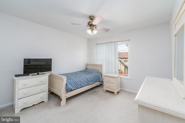 bedroom with light carpet, a ceiling fan, and baseboards