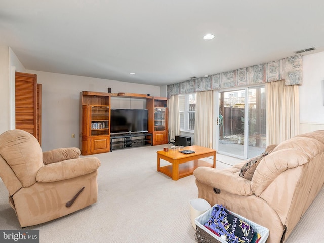 living area featuring carpet floors, visible vents, and recessed lighting