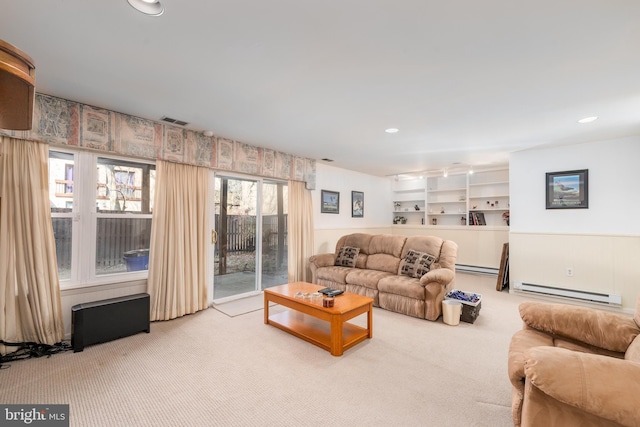 carpeted living area featuring a baseboard heating unit, visible vents, and recessed lighting