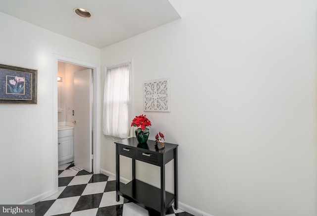 corridor with dark floors and baseboards