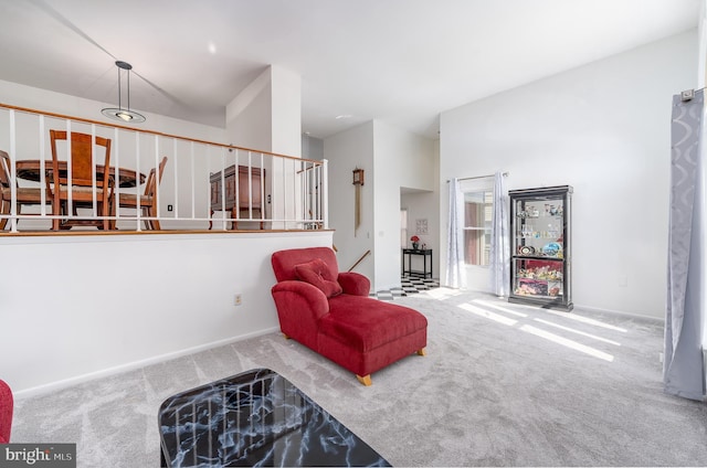 living area featuring carpet floors and baseboards