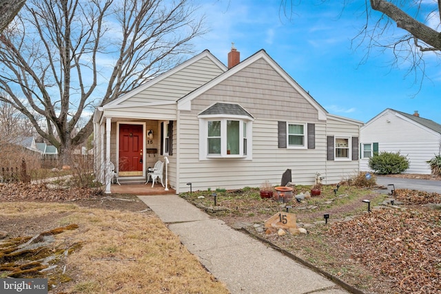 bungalow-style home with a chimney