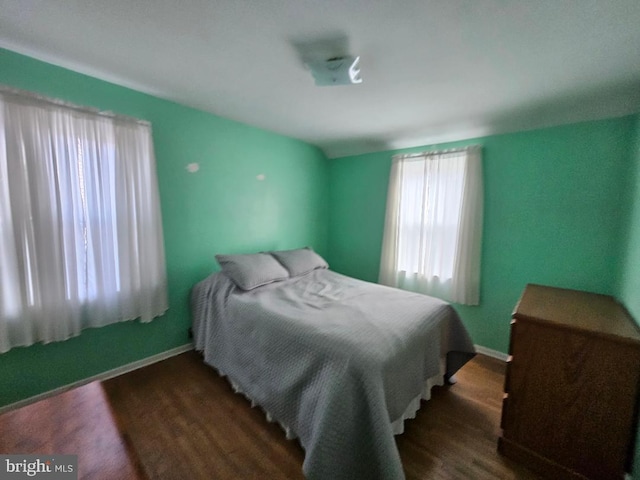 bedroom featuring wood finished floors and baseboards