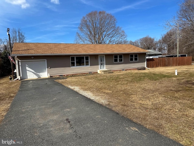 single story home with aphalt driveway, a front yard, entry steps, fence, and a garage