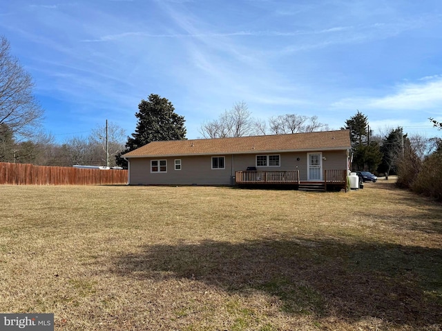 back of house with a yard, fence, and a deck