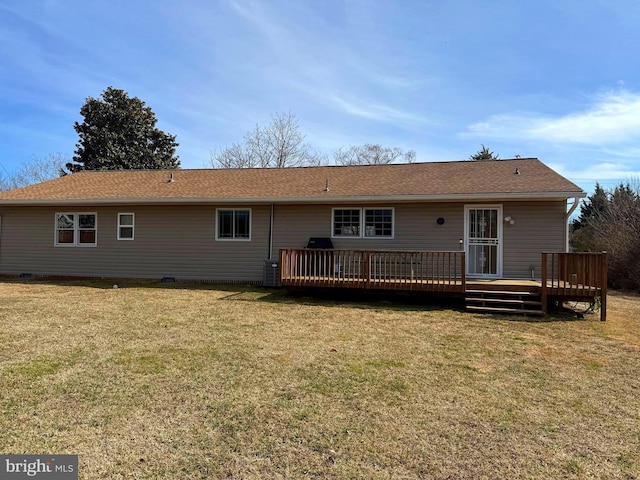 back of house with crawl space, cooling unit, a deck, and a lawn