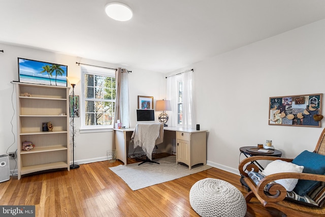 home office featuring light wood-type flooring and baseboards