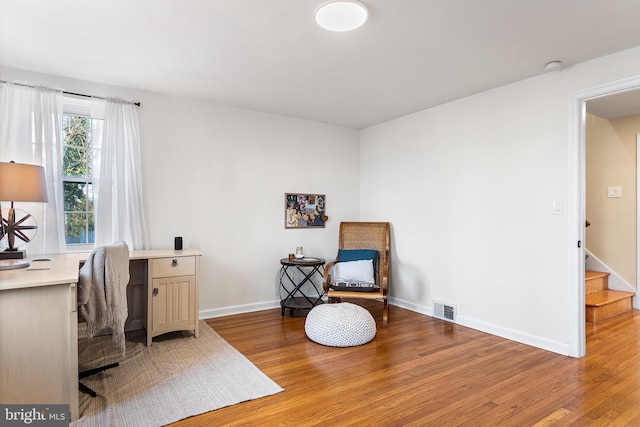 office featuring baseboards, visible vents, and light wood-style floors