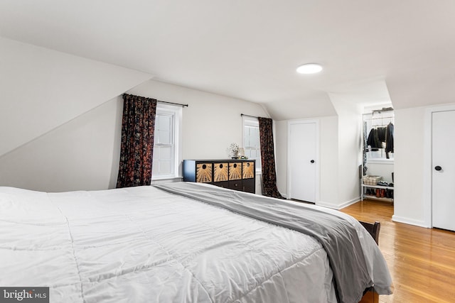 bedroom featuring baseboards and wood finished floors