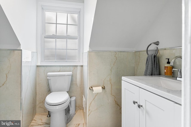 bathroom featuring marble finish floor, a wainscoted wall, vanity, and toilet