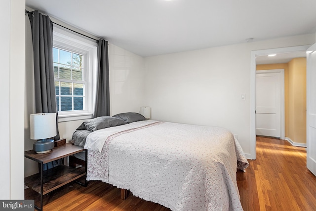 bedroom featuring wood finished floors and baseboards