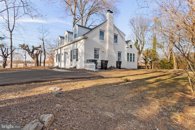 view of property exterior with a chimney