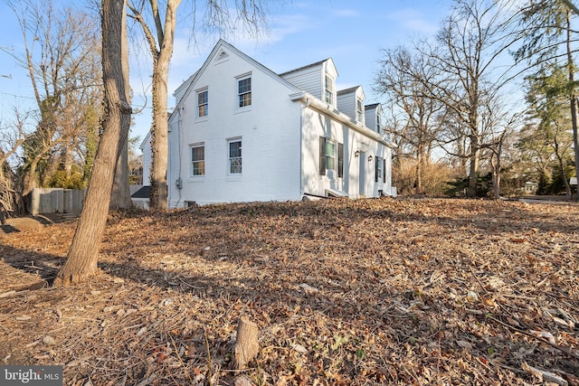 view of side of home with brick siding