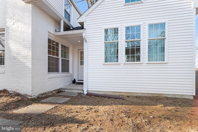 entrance to property featuring brick siding