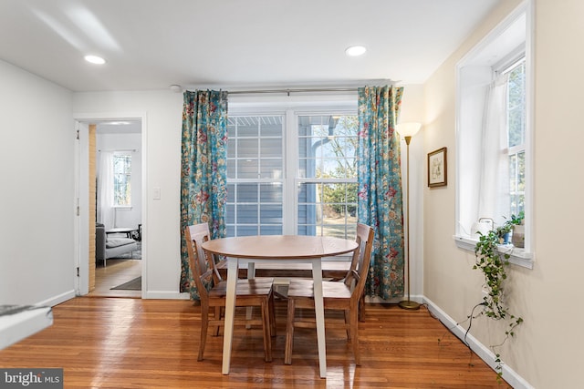 dining space featuring recessed lighting, baseboards, and wood finished floors