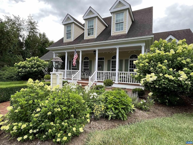 cape cod-style house featuring a porch