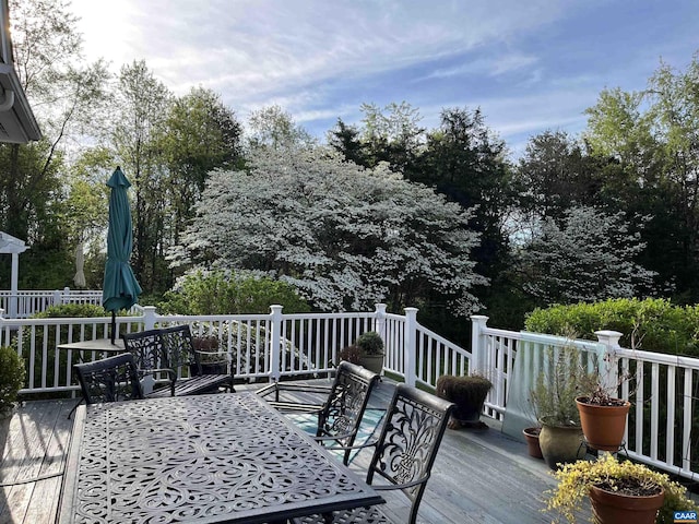 wooden terrace with outdoor dining space