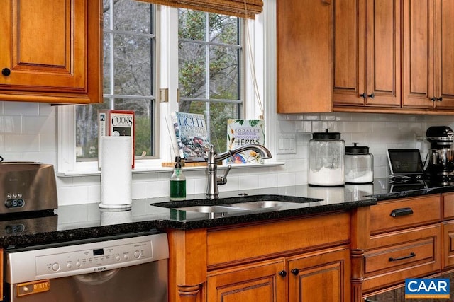 kitchen featuring backsplash, dishwasher, brown cabinets, and a sink